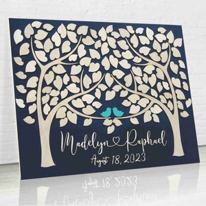 A guest book alternative made on a wood board and with two trees and leaves for guests to sign. the names of the bride + groom are under the trees, personalized per the names of the newlyweds. copyrighted image belongs to SignYouStyle