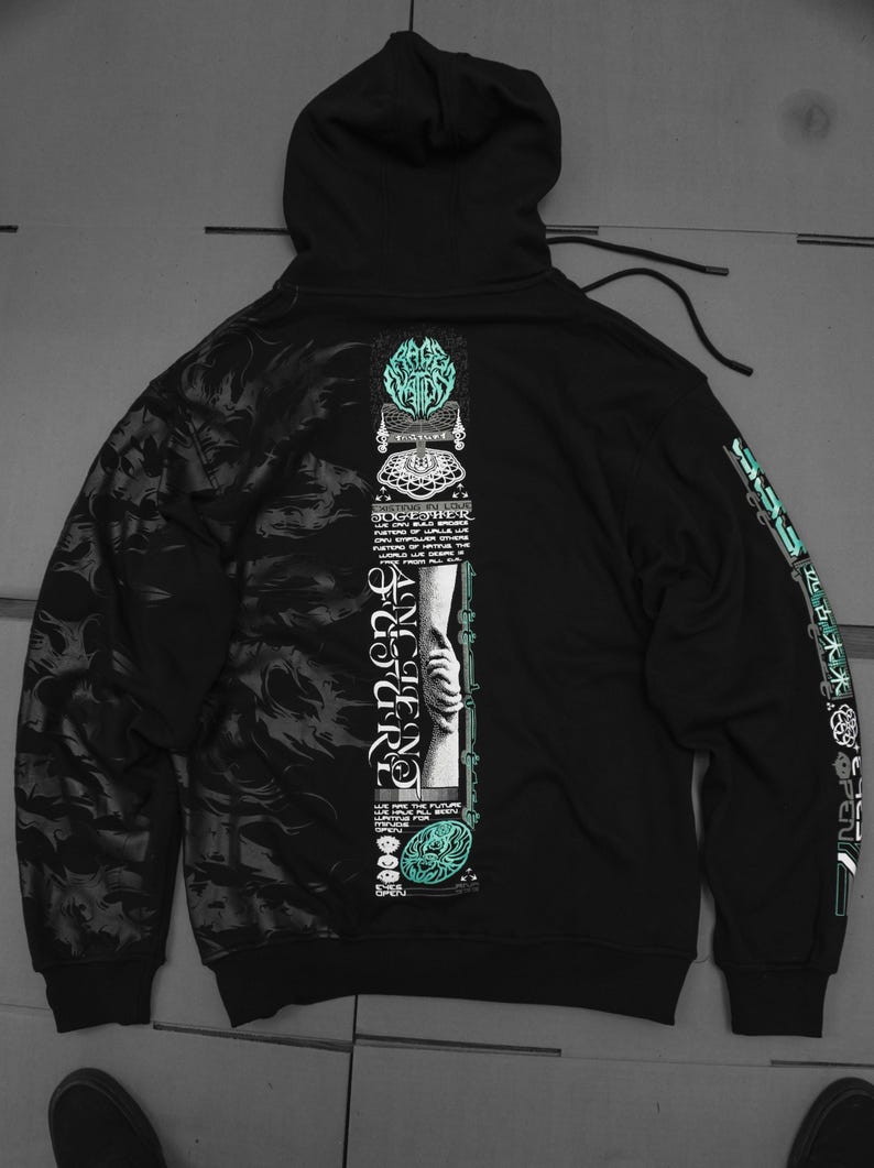 May include: Black hooded sweatshirt with a graphic print on the front and back. The front print features a hand holding a chain with the text "Ancient Code" and "Together" in a stylized font. The back print features a graphic with the text "Rage Against The Machine".