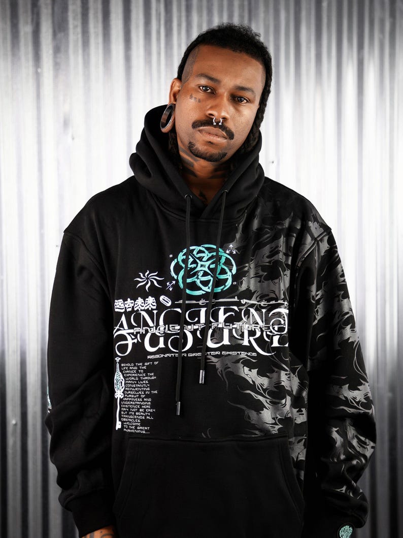 May include: Black hooded sweatshirt with a graphic print of a teal and white design. The design includes the words "Ancient Future" and "Resonante in a Greater Existence".