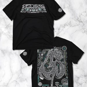 May include: Two black t-shirts with a white graphic design. The first shirt has the word "CYCLUS" in a stylized font with a geometric pattern. The second shirt has a large, stylized "3D" graphic with a mandala pattern.