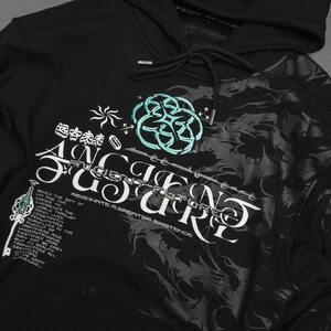 May include: Black hooded sweatshirt with a graphic print of a swirling design and the text "Ancient Future" and "RESONATE CREATOR EXISTENCE". The design is in white and teal.
