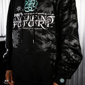 May include: Black hooded sweatshirt with a graphic print of a swirling design and the text "Ancient Future" in white and teal. The text "RESONATOR & EXISTENCE" is printed below the graphic.
