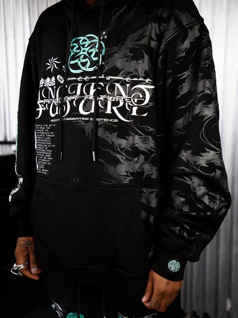 May include: Black hooded sweatshirt with a graphic print of a swirling design and the text "Ancient Future" in white and teal. The text "RESONATOR & EXISTENCE" is printed below the graphic.