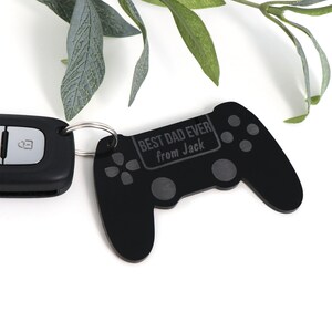 May include: Black plastic video game controller keyring with the text "Best Dad Ever from Jack" engraved on it.