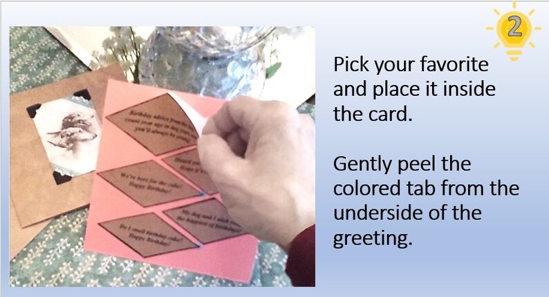 May include: A pink card with a variety of diamond-shaped paper tabs with different birthday wishes printed on them. The tabs are attached to the card with a peel-off adhesive. The instructions on the card read: "Pick your favorite and place it inside the card. Gently peel the colored tab from the underside of the greeting."