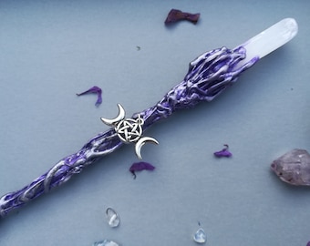 May include: A purple and silver wand with a clear crystal tip and a silver triple moon and pentacle charm.