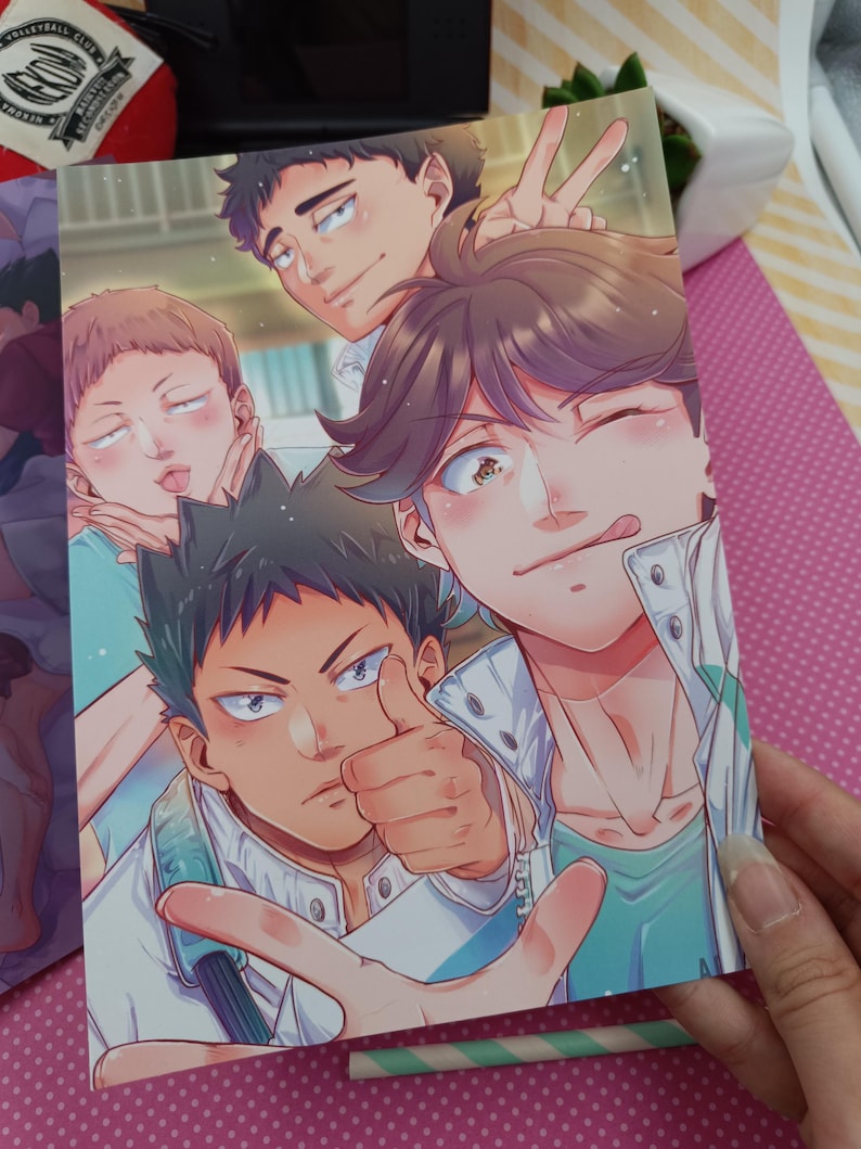 K&ouml;nnte beinhalten: Ein farbenfroher Druck im Anime-Stil mit einer Gruppe m&auml;nnlicher Charaktere, die f&uuml;r ein Selfie posieren. Die Charaktere haben verschiedene Ausdr&uuml;cke, darunter Daumen hoch, Friedenszeichen und verspielte Gesichter. Das Kunstwerk hat eine helle und fr&ouml;hliche &Auml;sthetik.