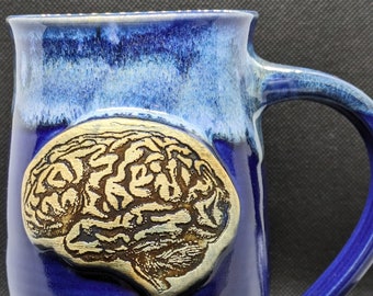 pottery coffee mug with a brain on it in black and white or blues