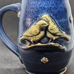 Pottery coffee mug with lovebirds on a branch in layered  blues