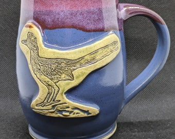 Handmade pottery coffee mug with roadrunner in merlot and blue