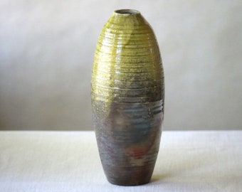 Tall narrow raku vase pottery: bottle shape vessel in yellow gold glaze with copper and red glaze flashing effects