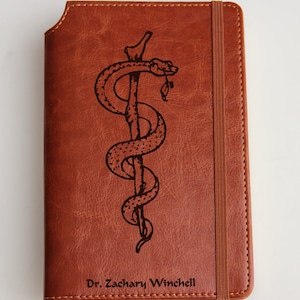 Carnet de notes personnalisé représentant Asclépios à partir de votre logo ou croquis Meilleur cadeau pour votre soeur, frère, fille, amis, maman, papa :