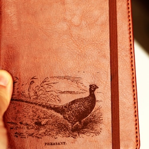 Customizable engraved pheasant zoological illustration journal leather bound, strip with the same color to keep it closed