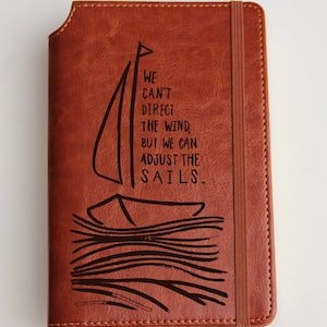 Laser engraved sailing boat Journal with custom quote  leather bound with elastic strip We can&#39;t direct the wind but we can adjust the sails