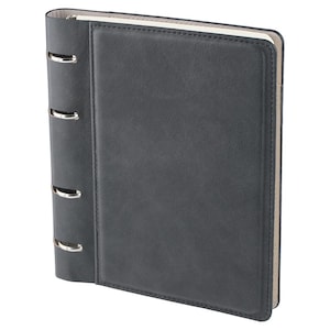 May include: A dark charcoal gray binder with a smooth, matte finish and a rectangular stitched border on the front cover. The spine features four silver-toned metal rings exposed along the side, with a light beige interior lining visible.