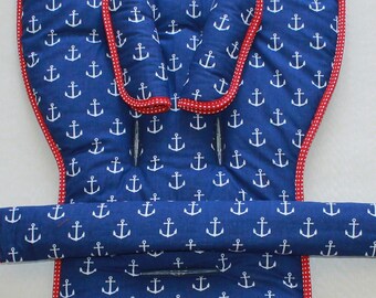 May include: A blue high chair cushion with a white anchor pattern and red trim. The cushion has two armrests and a strap for the waist.