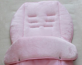 May include: Pink stroller footmuff with a soft fleece lining and a quilted outer layer. The footmuff has a zipper closure and a flap that can be folded down.