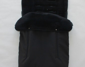 May include: Black stroller liner with a soft, plush lining. The liner has a zippered opening and a flap that can be folded down.