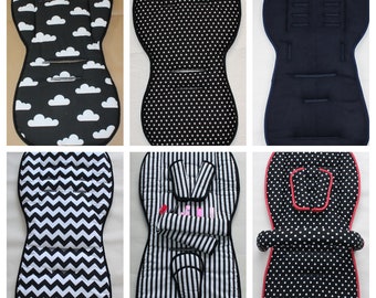 May include: Six different stroller seat cushions with various patterns. The patterns include clouds, polka dots, stripes, and zigzags. The cushions are all black and white except for one which is navy blue.