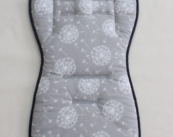 May include: Gray baby stroller seat cushion with a white dandelion print and black trim.