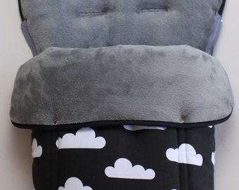 May include: A black stroller footmuff with a white cloud pattern. The footmuff has a gray fleece lining and a black zipper.