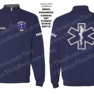 May include: A navy blue quarter-zip pullover sweatshirt with a white star of life and medical caduceus on the back. The front of the sweatshirt has a white patch with the text "JACKSON CITY EMS".