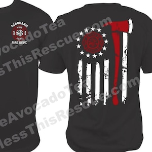 May include: Black t-shirt with a red and white fire department logo on the front and a distressed American flag with a red axe on the back. The text "KENNEY" and "SCHOHARIE FIRE DEPT." are on the shirt.