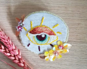 Yellow and orange eye, hand embroidery brooch with sequins and beads.