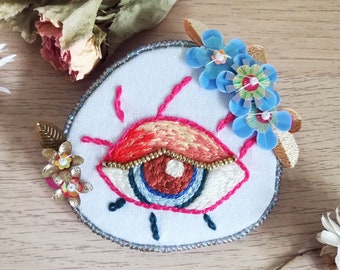 Pink and blue eye, hand embroidery brooch with sequins and beads.