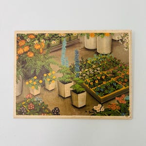 May include: Vintage botanical print featuring a vibrant display of potted flowers and plants. The artwork showcases a variety of blooms in white, yellow, orange, and blue, arranged in square and rectangular planters. The print has a light-colored border and is signed in the lower right corner.