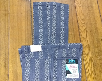 May include: Blue and white patterned slacks with a white label that says "Maverick's Boll's Slim Fitting Bell Bottom Slacks".