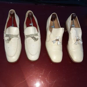 May include: Three pairs of white leather loafers with tassels. The loafers are on a red surface. The brand name "PARLOR CITY" is visible on the shoes.