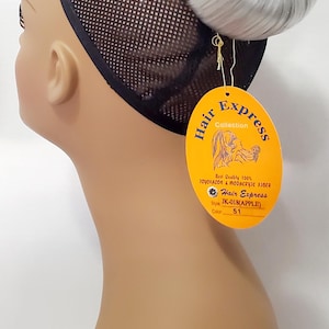 May include: A mannequin head with a silver-gray hair bun wig. The wig is attached to a black mesh cap. A yellow tag from "Hair Express Collection" hangs from the wig, with product details.