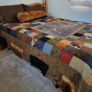 May include: A bed with a patchwork quilt in various colors, including blue, green, and brown. The bed has brown pillows and a faux fur bolster pillow. Faux fur accents are attached to the bed skirt. A gray rug is on the floor.