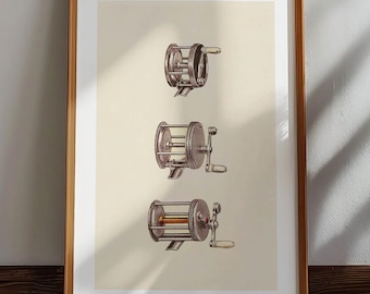 May include: Framed print featuring three vintage fishing reel illustrations. The reels are depicted in detail with a neutral color palette, set against a cream-colored background. The wooden frame adds a classic touch to the artwork, suitable for home decor.