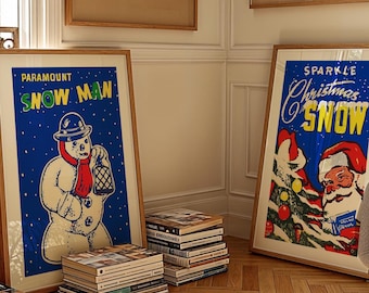 May include: Two framed vintage Christmas posters. The poster on the left features a snowman with a red scarf and a lantern, with the text "PARAMOUNT SNOW MAN". The poster on the right features Santa Claus holding a Christmas tree with the text "SPARKLE Christmas SNOW".