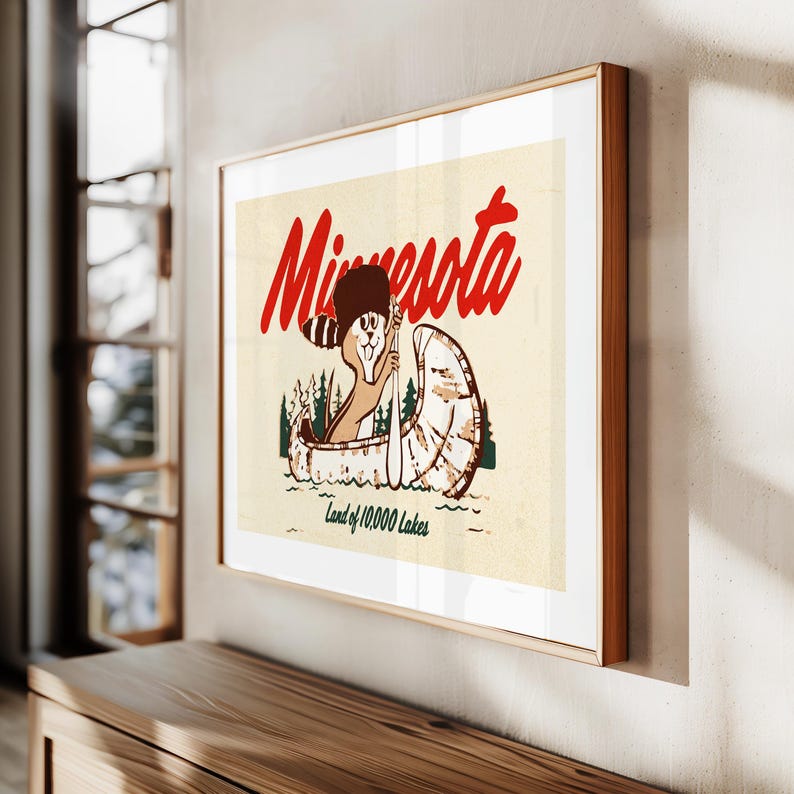 May include: A vintage-style poster featuring a cartoon raccoon in a canoe paddling on a lake. The poster is titled "Minnesota, Land of 10,000 Lakes".