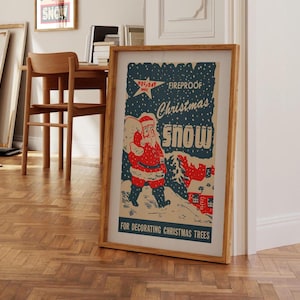 May include: Vintage Christmas snow decoration poster featuring a cartoon Santa Claus carrying a bag of gifts. The poster has a blue background with white snowflakes and the text "Fireproof Christmas Snow" in red and white. The poster also includes the text "For Decorating Christmas Trees".