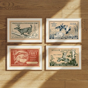May include: Four framed vintage hunting stamps. The stamps feature illustrations of a deer, ducks, a trout, and a turkey. The stamps include text such as "Virginia Bear and Deer Hunting Stamp" and "Wildlife Conservation".
