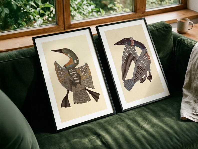 May include: Two framed art prints featuring stylized loon illustrations on a cream background. Each print is encased in a thin black frame, showcasing detailed bird figures with intricate patterns in shades of brown, gray, and white.
