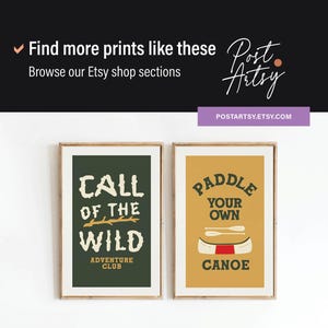 May include: Two framed art prints with outdoor adventure themes. One features "Call of the Wild" text on a dark green background. The other says "Paddle Your Own Canoe" on a mustard yellow background. The prints are in wooden frames.