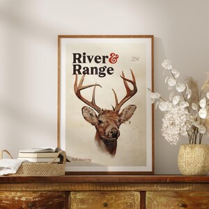 May include: A vintage poster with a brown background featuring a white-tailed deer with large antlers. The poster is framed in wood and has the text "River & Range" and "25&cent;" printed in red and black. The text "Fall Hunting" is printed in black at the bottom of the poster.