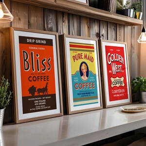 May include: Three framed vintage coffee advertisements. The Bliss Coffee poster is orange with black text and illustrations. The Pure Maid Coffee poster is yellow and blue with a woman's portrait. The Golden West Coffee poster is red with white text.