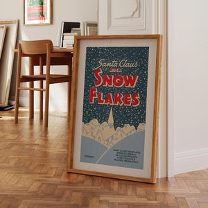May include: A vintage-style poster with a blue background and white snowflakes. The poster features the text "Santa Claus with Snow Flakes" in red and white lettering.