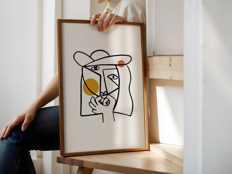 May include: A framed abstract line drawing of a person's face with a hat, yellow and red circles, and a white background.