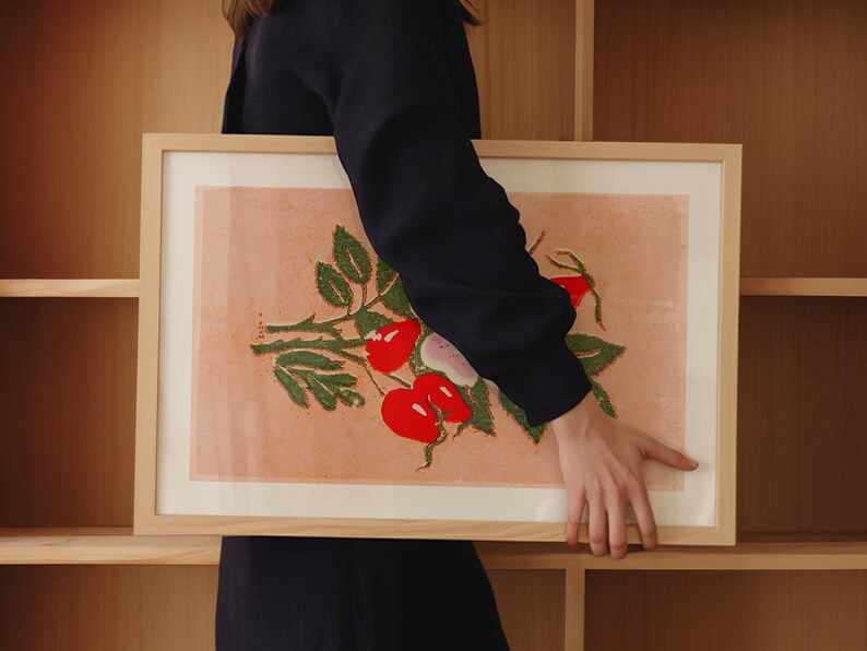 May include: A framed print of a botanical illustration featuring a green plant with red berries on a peach background.