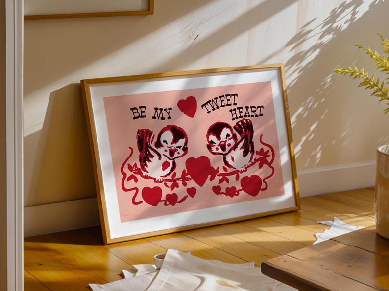 May include: A framed print with a pink background featuring two cartoon birds with red hearts and the text "Be My Tweet Heart".