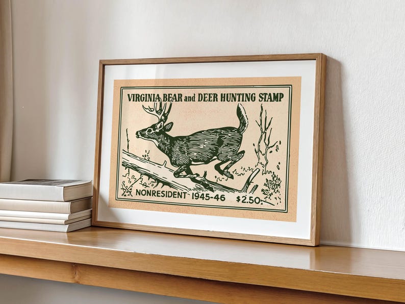 May include: Framed vintage print of a deer leaping over a log, labeled "Virginia Bear and Deer Hunting Stamp." The artwork is in shades of green and brown, with text indicating it's for nonresident hunters from 1945-46.
