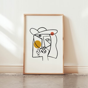 May include: A black and white line drawing of a face with a yellow circle and a red circle on the face. The face is wearing a hat.