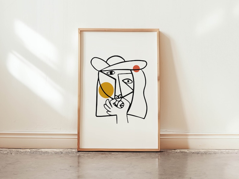 May include: A black and white line drawing of a face with a yellow circle and a red circle on the face. The face is wearing a hat.